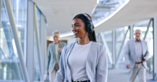 Headphones, music and business woman dance in office walking with celebration for weekend. Company, female worker and web radio listening to audio feeling happy with freedom and web song with smile. - Footage, Video