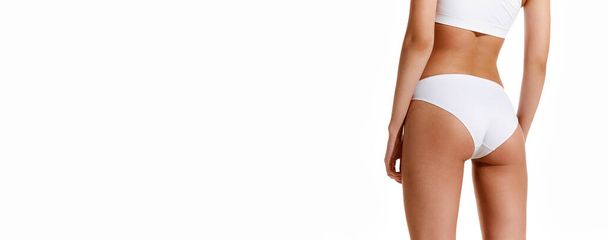 Banner. Slim, fit, female body, buttocks in white lingerie isolated over light background. Anti-cellulite cosmetology. Fitness. Fitness. Concept of beauty, body care, health, diet, cosmetics, spa. Ad - Photo, Image