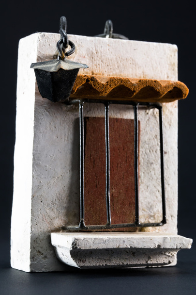 Lantern above door, pumice-stone souvenir on black background - Photo, Image