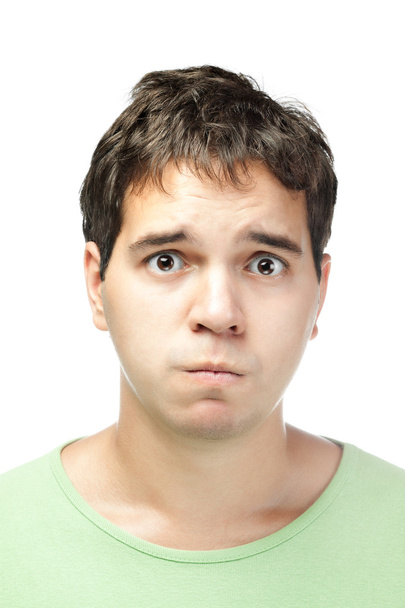 Portrait of pitiful young man isolated on white background - 写真・画像