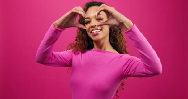 Happy cute young woman makes heart hand gesture, Valentines Day studio. High quality 4k footage - Footage, Video