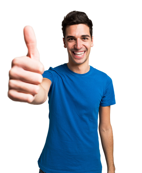 Young man giving thumbs up - Foto, immagini