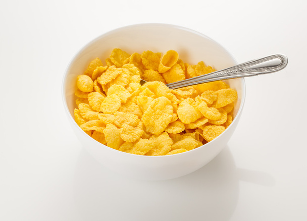 Gele cornflakes met lepel - Foto, afbeelding