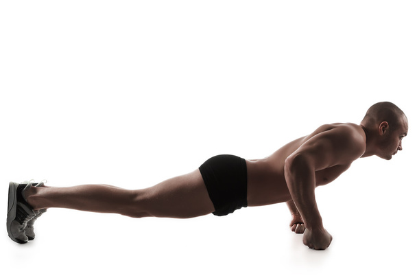 Man performing push-ups exercise - Fotó, kép
