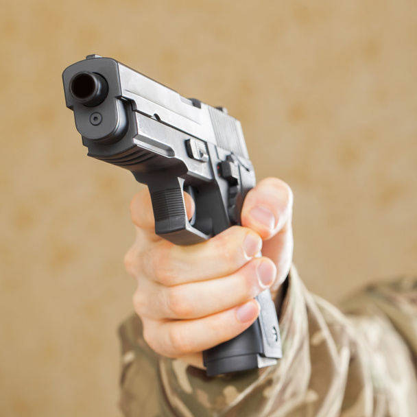 Man in black mask holding gun and ready to shot - Foto, Imagem