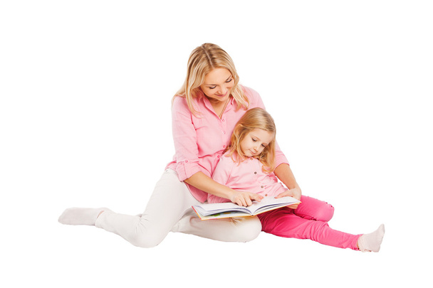 Little girl read book with mother - Фото, зображення