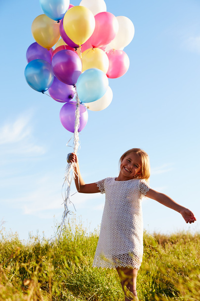 Young Girl Holding  Balloons - Foto, afbeelding