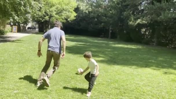 Father and Son Enjoy Soccer Dribbling Fun on a Sunny Day - Footage, Video