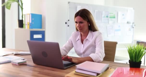 Frustrated businesswoman looking at laptop monitor and feeling dissatisfied with email received. Unhappy woman reading bad news notice and solving financial problem - Footage, Video