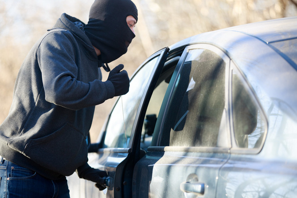 Thief stealing automobile car at daylight street in city - Valokuva, kuva