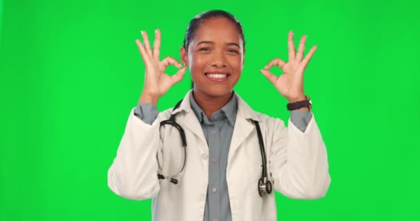 Okay sign, face and doctor on green screen for healthcare success, support or excellence in services. Happy medical worker or latino woman for agreement, good job or yes hands on a studio background. - Footage, Video