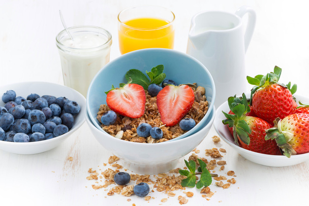 healthy breakfast - granola, fresh berries and milk, close-up - Photo, Image