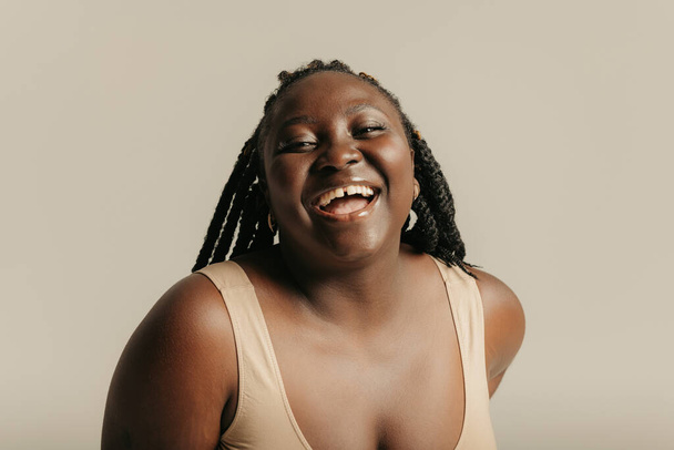 Portrait of curvy African woman looking at camera and smiling on studio background - Φωτογραφία, εικόνα