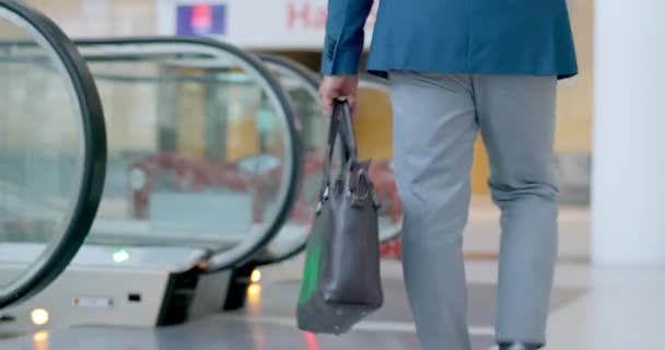 Businessman, walking and escalator in office lobby or entrance to building of work, business or tradeshow convention. Moving, stairs and man with bag for laptop, technology or travel with briefcase. - Footage, Video