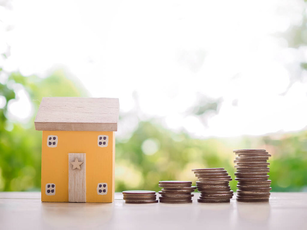 Miniature house and stack of coins. The concept of saving money for house, Property investment, House mortgage, Real estste. - Photo, Image
