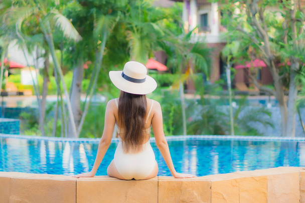 Retrato hermosa joven mujer asiática relajarse alrededor de la piscina en el complejo hotelero para el ocio en vacaciones - Foto, Imagen