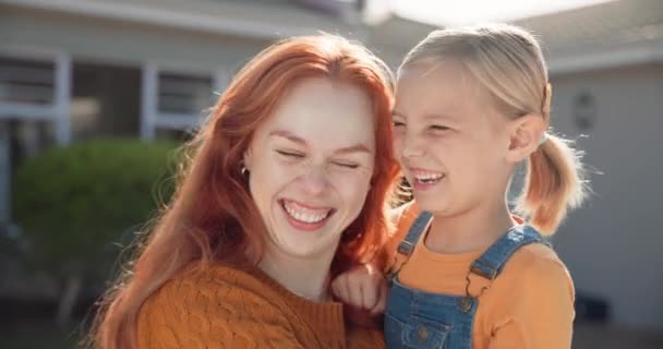Happy, smile and mother hugging her child while standing, bonding and playing in their backyard. Happiness, love and young mom embracing her girl kid while enjoying fresh air in the garden at home - Video