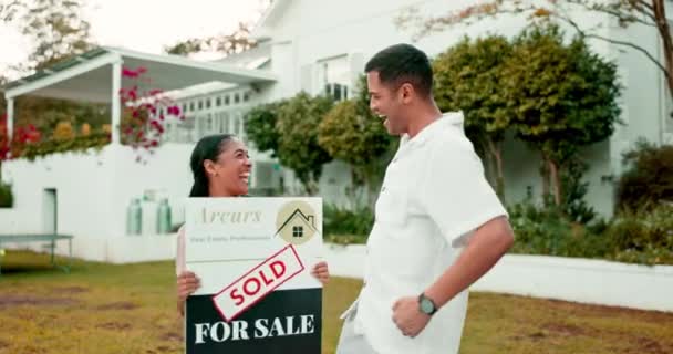 Property, high five and a homeowner couple with a sold sign in the garden of their new house together. Love, mortgage or real estate with a married man and woman in celebration of home ownership. - Footage, Video