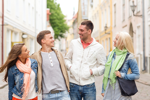 group of smiling friends walking in the city - Fotoğraf, Görsel