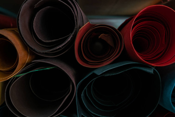 Colorful raw genuine vegetable tanned leather on shelf in crafts shop, Handmade market - Photo, Image