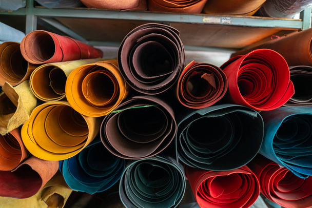 Colorful raw genuine vegetable tanned leather on shelf in crafts shop, Handmade market - Photo, Image