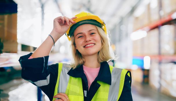 Young woman happy standing and looking at camera. Female warehouse worker smiley and smart confident at storehouse - Valokuva, kuva