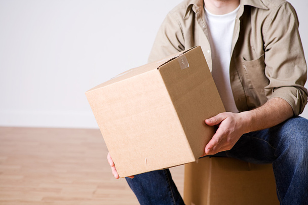 Moving: Man Sitting With Packed Cardboard Box - Foto, afbeelding