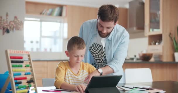 Family, education and a father helping his son with homework or to study while teaching in the kitchen. Tutor, school and a young boy student distance learning or home schooling with a male parent. - Footage, Video