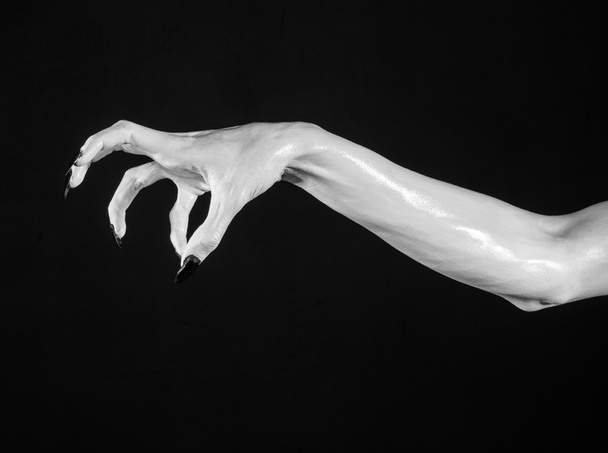 white hands of death with black nails, white death, the devil's hands, the hands of a demon, white skin, halloween theme, black background, isolated - Foto, Imagem