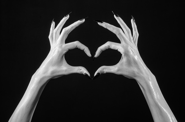 white hands of death with black nails, white death, the devil's hands, the hands of a demon, white skin, halloween theme, black background, isolated - Foto, Bild