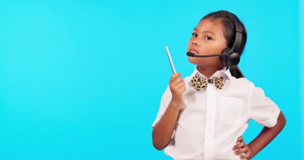 Decision, child thinking and with headset against a blue background for choice. Idea or plan, mockup space or brainstorming and young female person pose for online communication or telemarketing. - Footage, Video