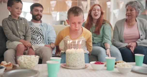 Blowing, birthday boy or big family with cake in celebration or house party with support, candles or love. Grandmother, grandfather or excited child eating baked desert with dad, mom or grandparents. - Footage, Video