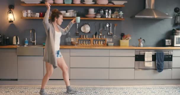 Music, woman dance with coffee and in a kitchen of her home. Happiness or celebration, freedom and female person celebrate with dance for success or health wellness at her house in the morning. - Footage, Video