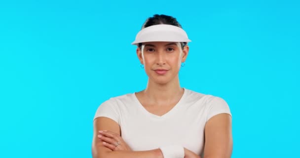 Serious, sports and face of a woman with arms crossed isolated on a blue background in a studio. Ready, fitness portrait and a girl or expert athlete for tennis, sports or training motivation. - Footage, Video
