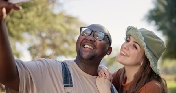 Interracial, couple and selfie, camping in nature with happiness and social media post with friends. Live streaming, peace hand sign and memory, black man and woman outdoor with smile in picture. - Footage, Video