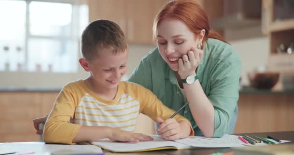 Family, school and a mother helping her son with his homework or to study or write in the kitchen. Tutor, education and a happy young boy student distance learning or home schooling with a parent. - Footage, Video