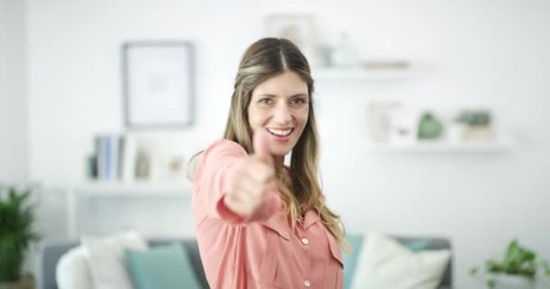 Happy woman, face and thumbs up for winning, success or victory in achievement or accomplish at home. Portrait of female person smiling showing thumb emoji, yes sign or like in happiness for approval. - Footage, Video