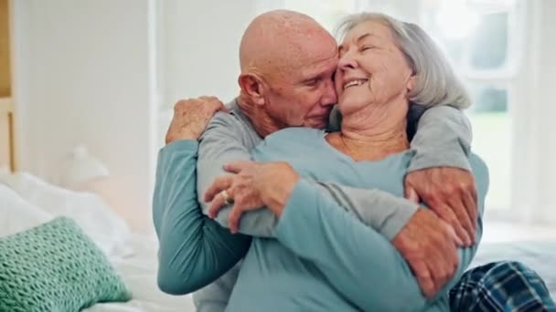Senior couple, hug and love in bedroom, care and conversation together at home. Embrace, elderly man and happy woman in bed, romance and connection for support, relationship or commitment to marriage. - Footage, Video