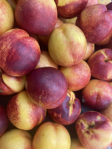 Pile of Georgia Peaches on display in a grocery store food backgrounds - Photo, Image