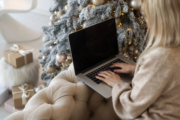 Portrait of attractive cheerful girl watching video resting at christmas. - Photo, Image