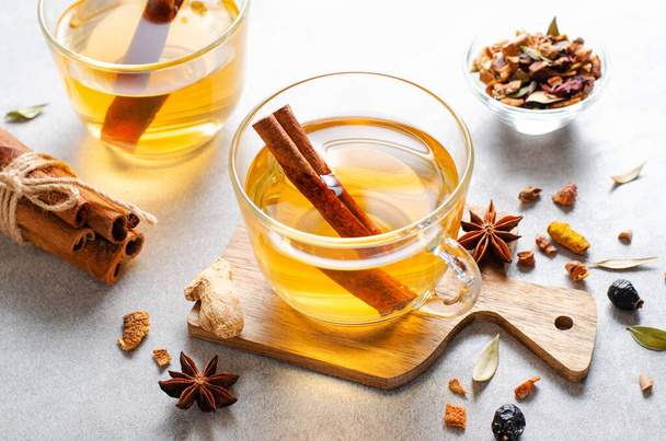 Tè caldo autunnale o invernale, tisana con spezie in una tazza su sfondo luminoso - Foto, immagini