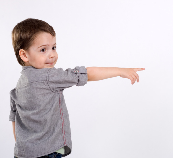 A little boy points at something - Фото, зображення