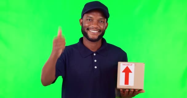 Thank you, delivery man with box and thumbs up against green screen for logistics. Success or achievement, courier or distribution and happy male person with parcel for ecommerce with mockup space - Footage, Video
