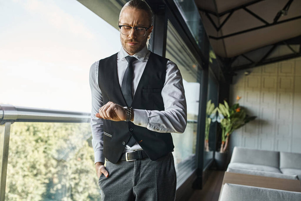 elegant professional with dapper style with glasses looking at his wristwatch, business concept - Photo, Image