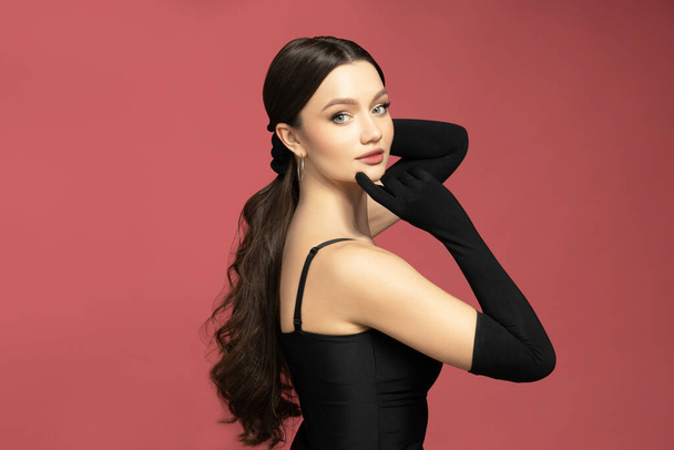 Attractive girl in a black dress and black gloves - Фото, изображение