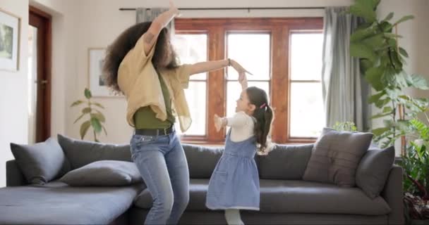 Dance, excited and mother with daughter in home for bonding, quality time and loving relationship. Family, happy parent and mom with child in living room for dancing, learning and teaching moves. - Footage, Video
