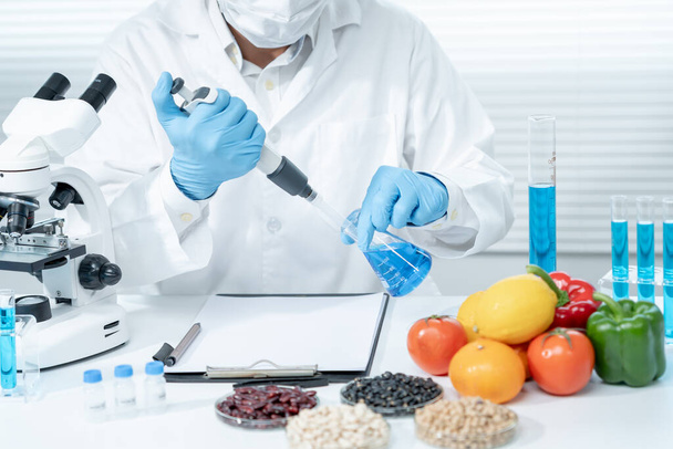 Scientist check chemical food residues in laboratory. Control experts inspect quality of vegetables  vegetables. lab, hazards, find prohibited substances, contaminate, Microscope, Microbiologist - Photo, Image