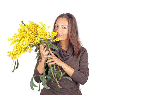 Beautiful woman with blossoming mimosa - Photo, Image