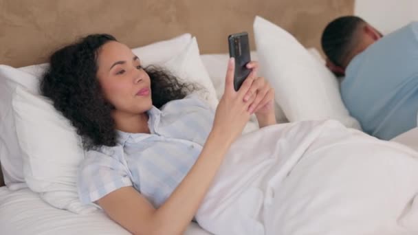 Bedroom, phone and relax couple, happy woman or girl typing, search or reading online news, social network or blog post. Home bed, happiness and person smile for mobile notification, message or text. - Footage, Video