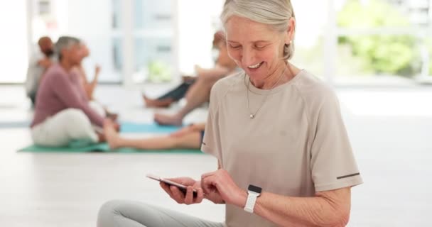 Smart watch, meditation and senior woman with a smartphone, yoga and smile with progress, health and fitness. Old person, happy pensioner and mature lady with a cellphone, check time and exercise. - Footage, Video